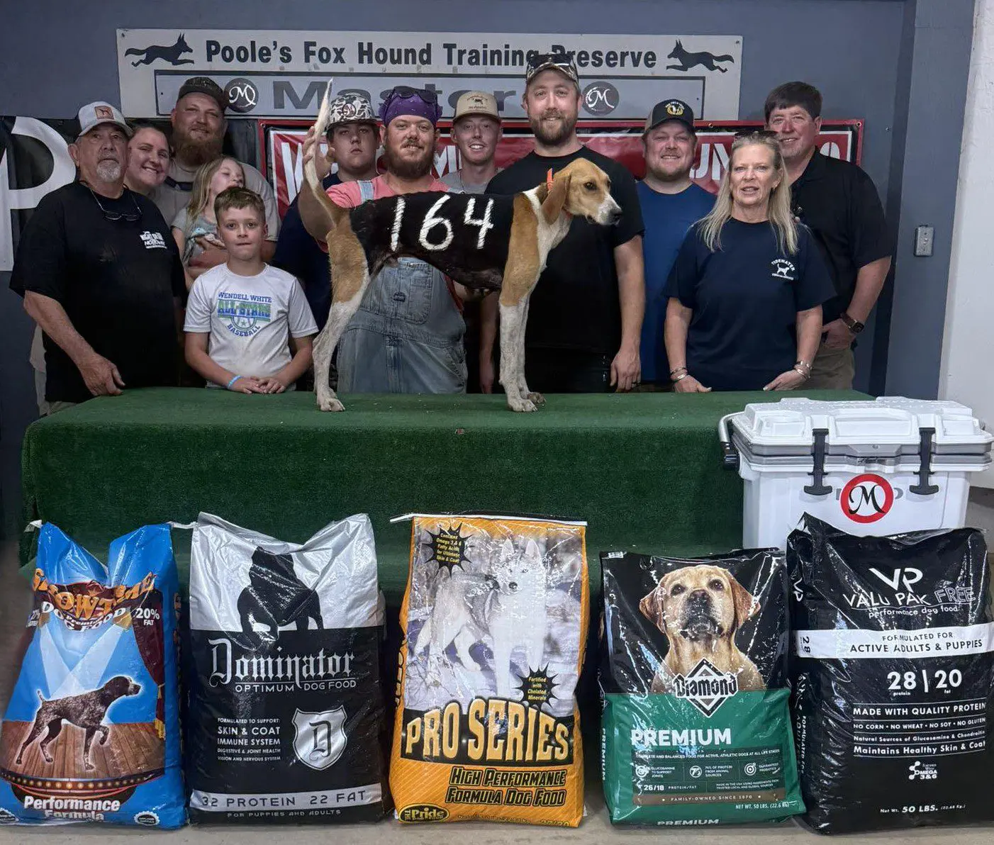 Group with a dog and pet food bags.