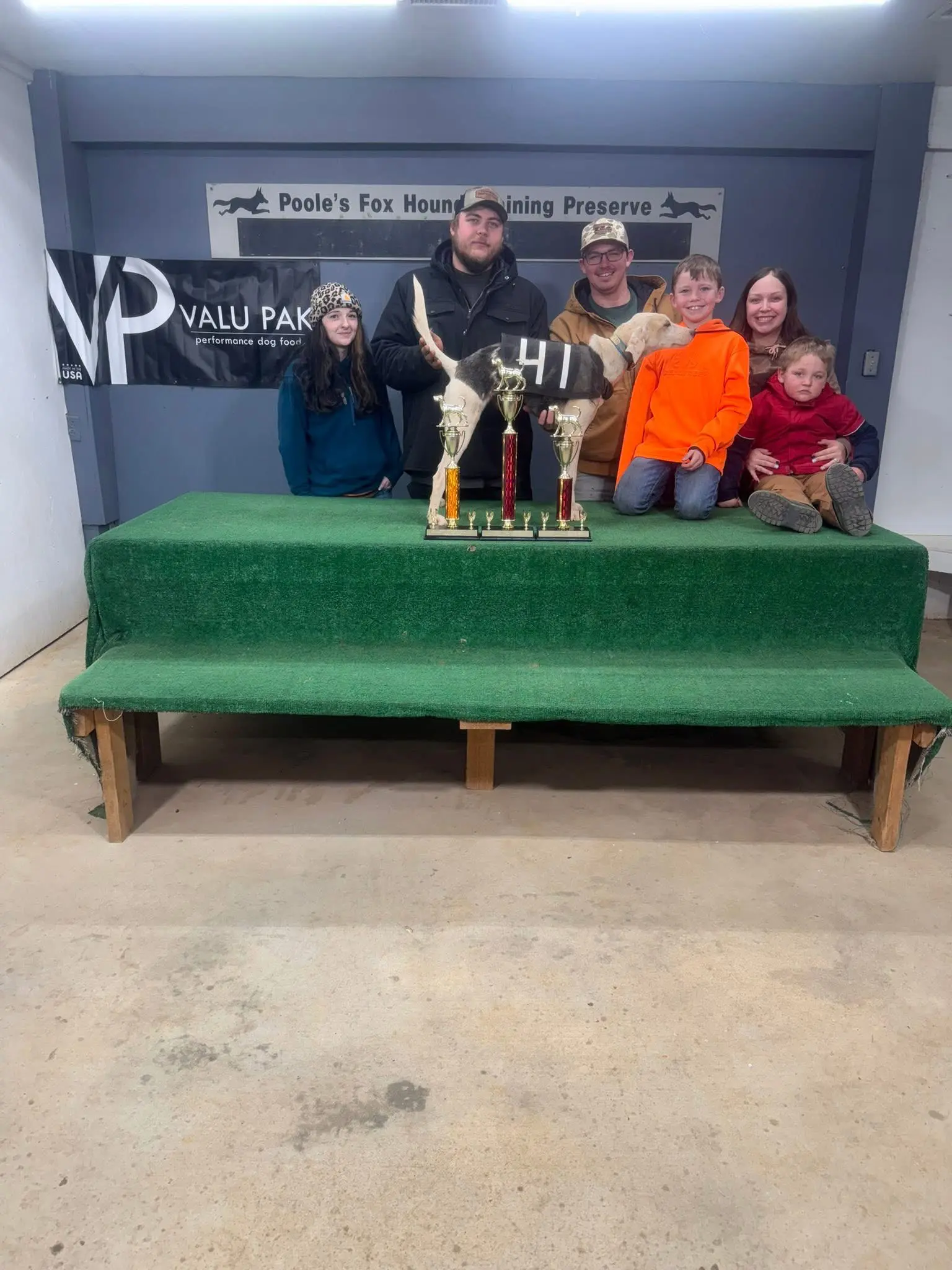 Group with trophies and hunting training banner.